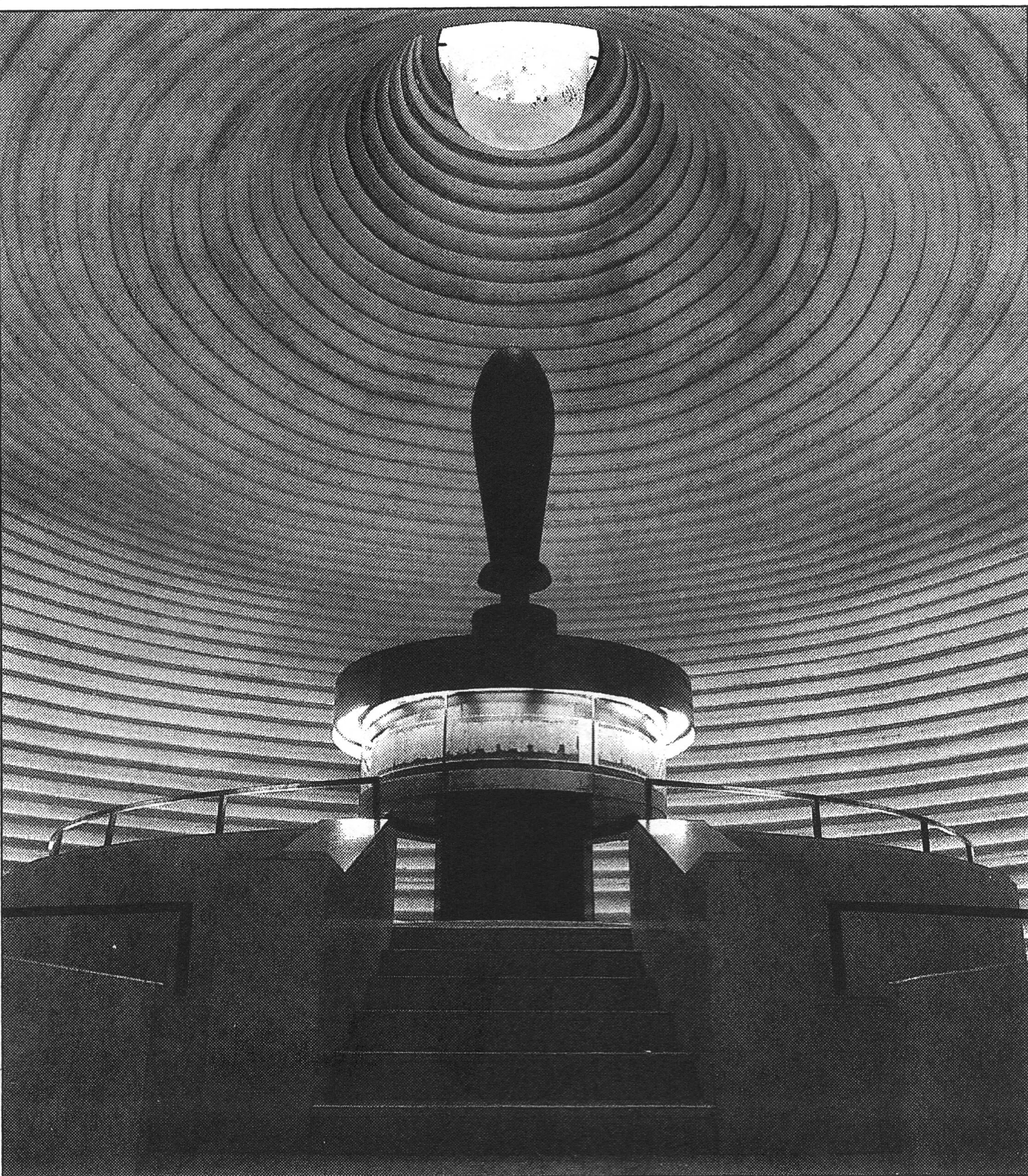 Interior of the Israel Museum's Shrine of the Book. The Great Isaiah Scroll is centrally exhibited in a circular display case. The ingenious design of this display, which gives the impression of a scroll, has one flaw—the giant scroll handle. Apparently the architects did not realize that this element of the scroll motif was anachronistic, contrary to ancient Jewish custom in the period from which the Dead Sea Scrolls date. (Courtesy of the Shrine of the Book, Israel Museum. Photo: David Harris)