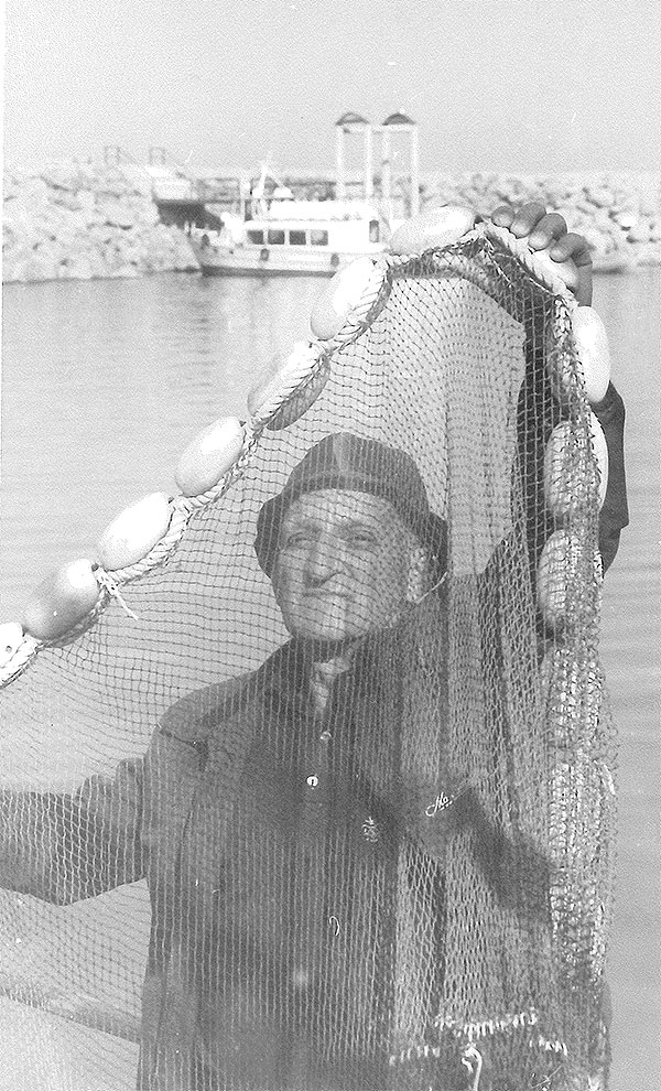Mendel Nun holding a fishing seine.
