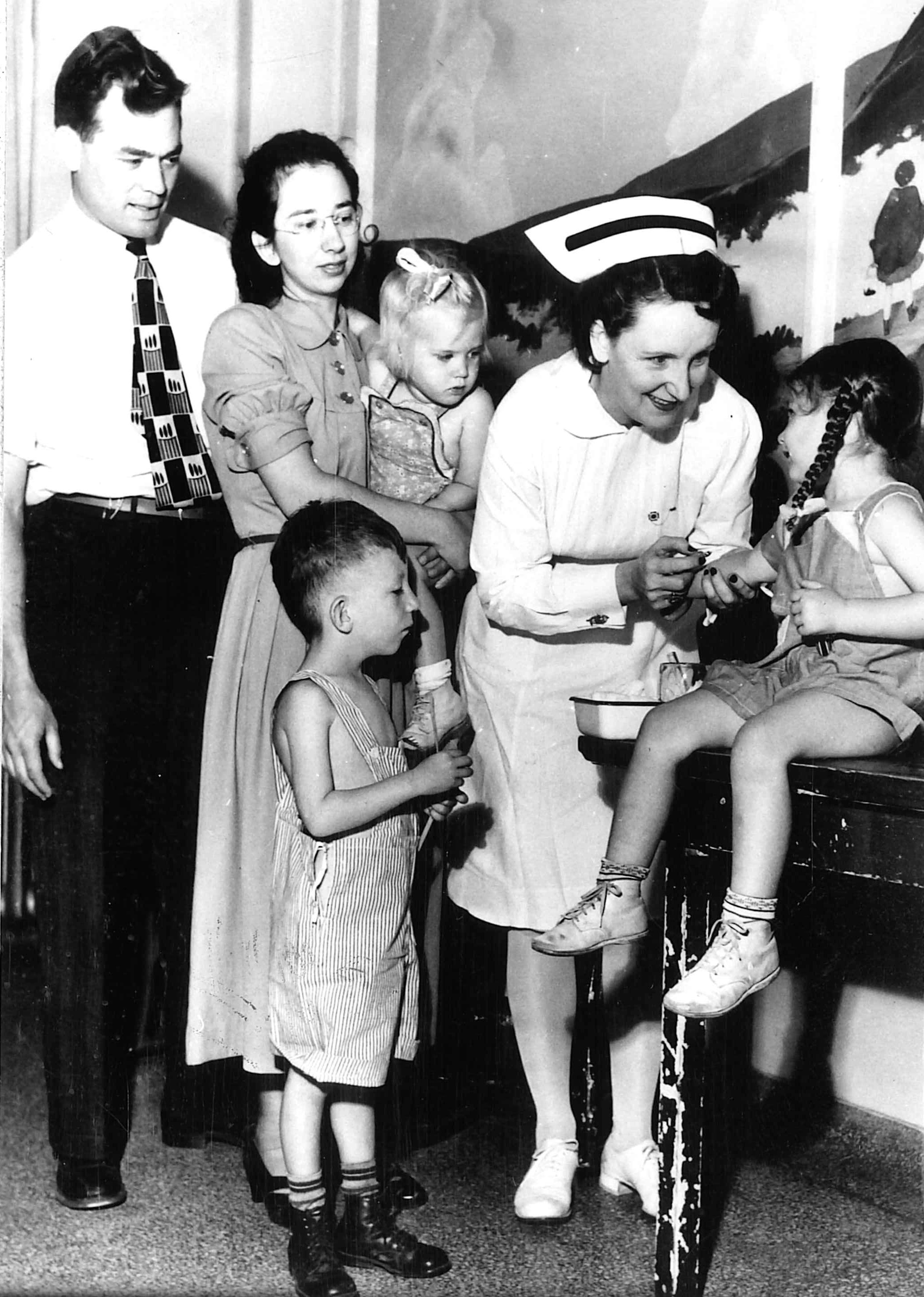 During their first furlough, members of the Lindsey family “enjoy” a checkup (Dallas, Texas, Jun. 1948).