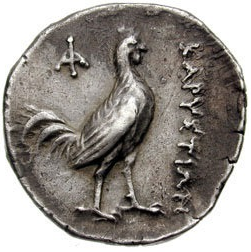 Coin from Karystos, Euboea (a Greek island) depicting a rooster and bearing the inscription ΚΑΡΥΣΤΙΩΝ (ca. 313-265 B.C.E). Image courtesy of the <a href="https://www.cngcoins.com/Coin.aspx?CoinID=30427" target="_blank" rel="noopener noreferrer">Classical Numismatic Group</a>.