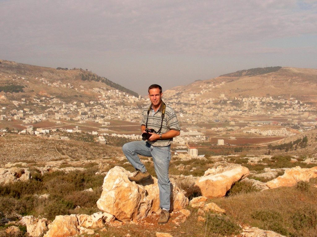Todd Bolen with Mount Gerizim and Mount Ebal in the background.