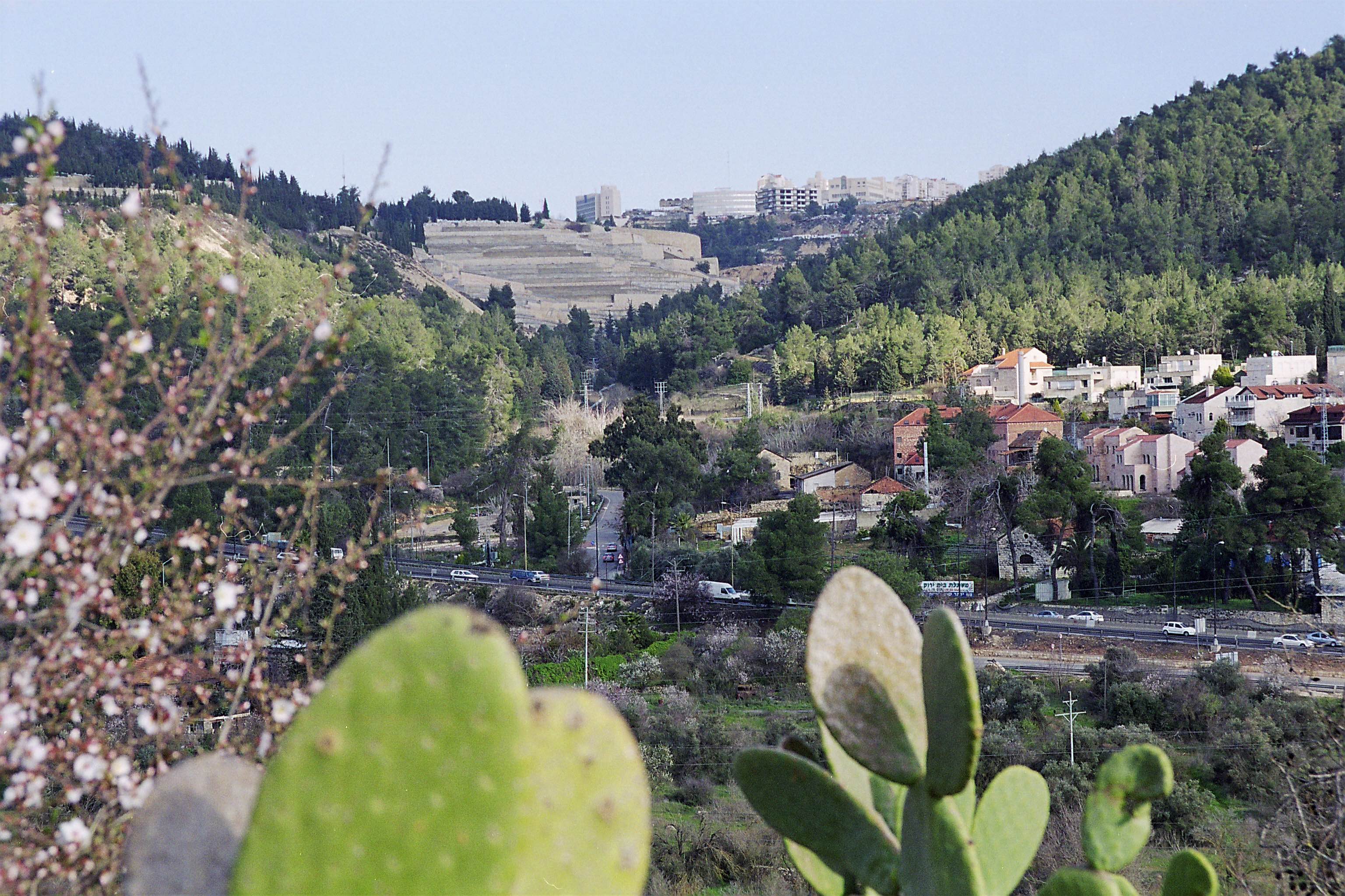 Facing east toward Jerusalem up the valley through which the road to Emmaus once ran. The Har Hamenuhot cemetery, the light colored structure in the center of the photo, now dominates the landscape.