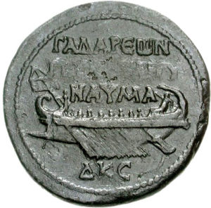 A medallion from Gadara dated to 160/161 C.E. depicting a seagoing vessel. The inscription reads ΓAΔAPΕΩN/T[HCKA]TAIΓY/NAYMA, which refers to the naval games Gadara sponsored. Image courtesy of the <a href="https://cngcoins.com/Coin.aspx?CoinID=140369" target="_blank" rel="noreferrer noopener">Classical Numismatic Group</a>.
